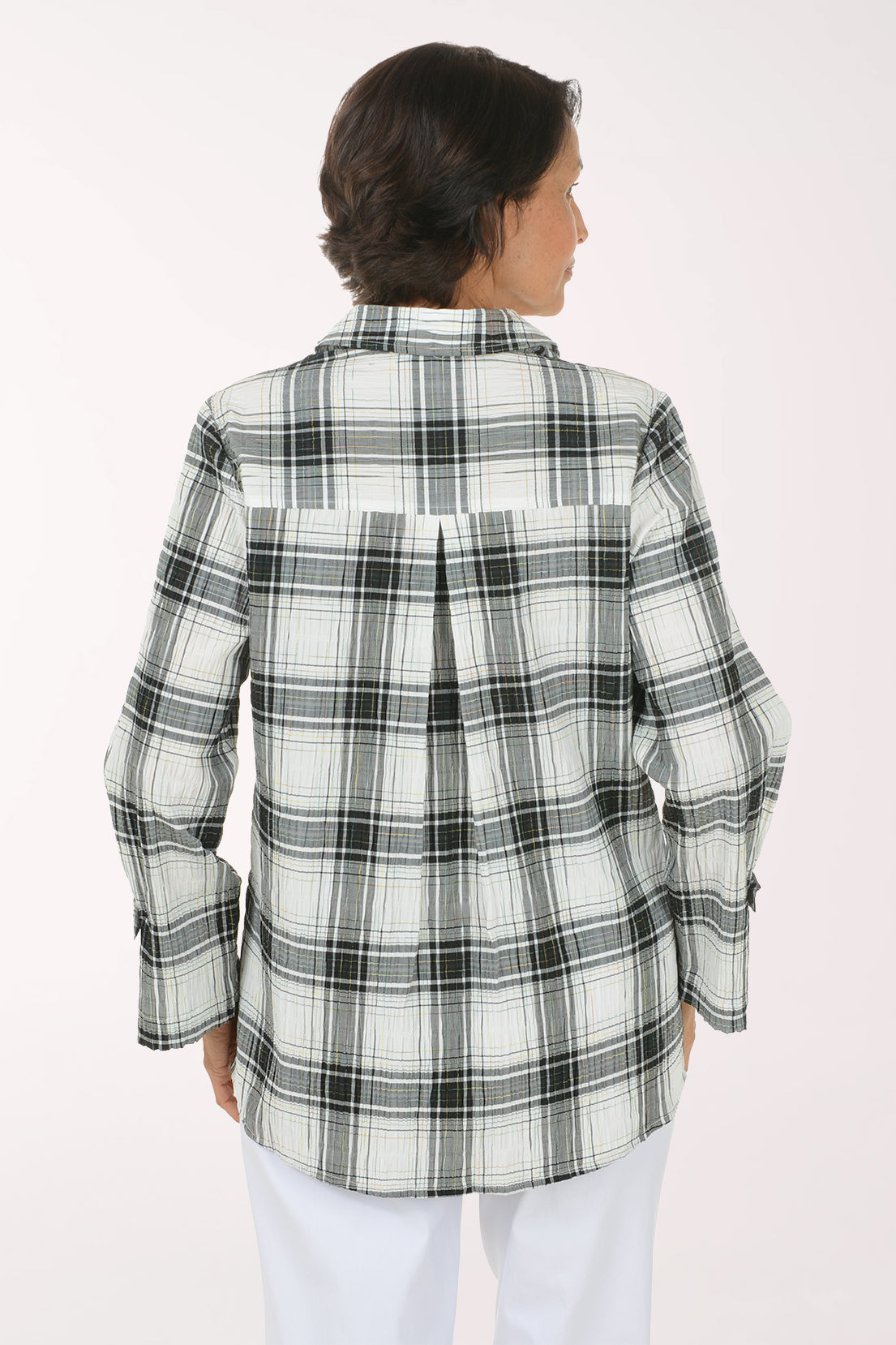 Woman wearing a black and white plaid collared top