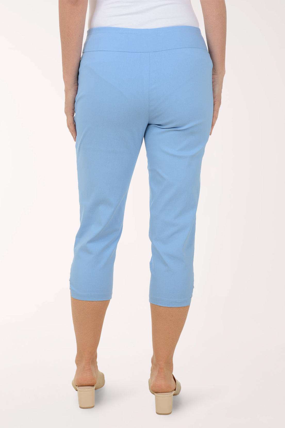 Light blue capri pants worn by a person on a white background