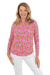 Woman wearing a pink floral patterned blouse on a white background.