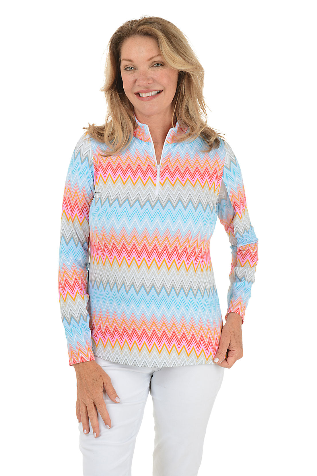 Woman wearing a colorful zigzag patterned pullover on a white background.