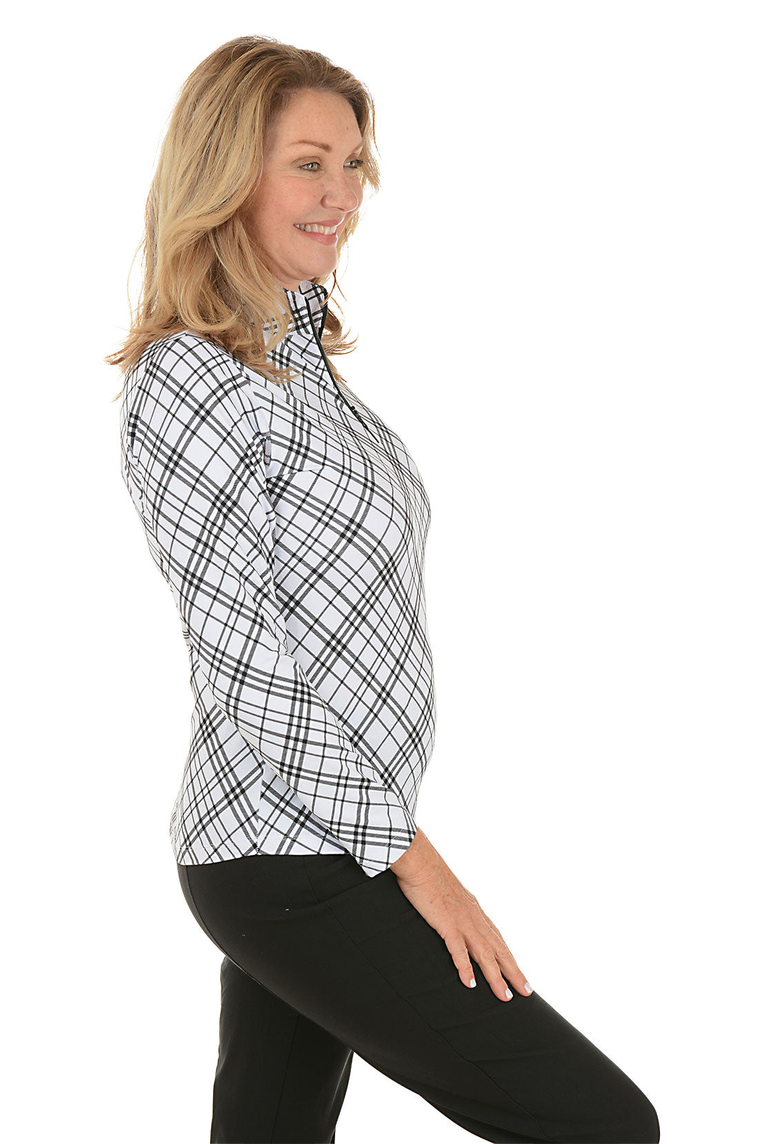 Woman wearing a black and white checkered shirt on a white background. Side shot.