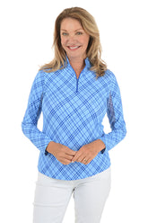 Woman wearing a blue checkered long-sleeve shirt on a white background.