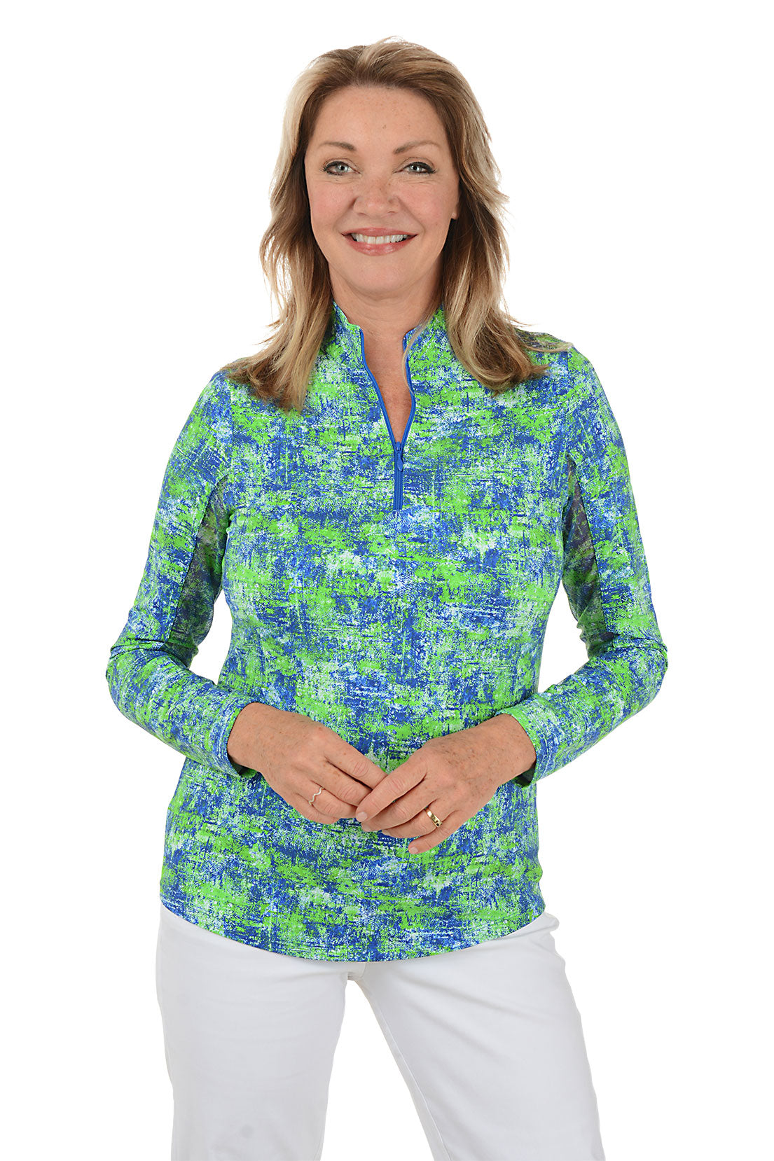 Woman wearing a colorful patterned long-sleeve shirt on a white background.