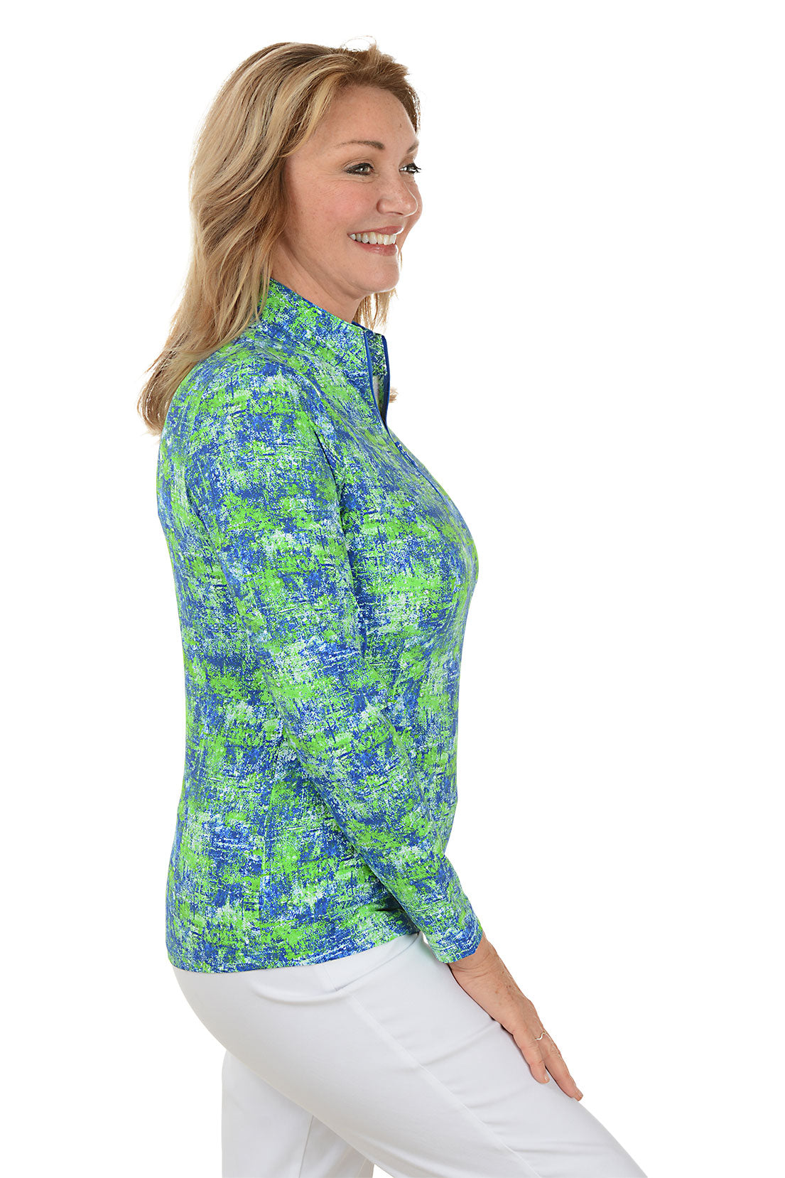 Woman wearing a colorful patterned long-sleeve shirt on a white background. Side shot.