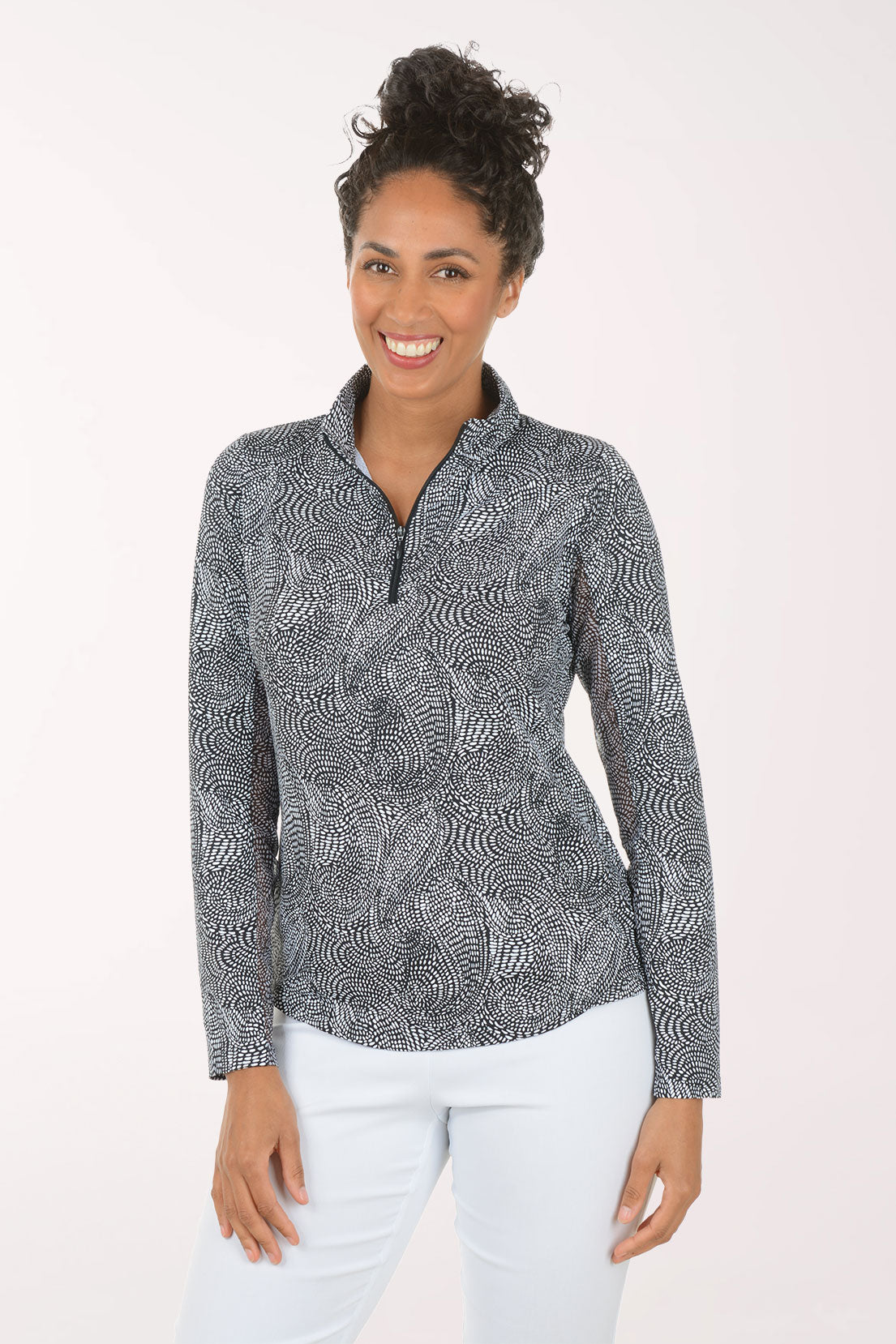 Woman wearing a patterned long-sleeve shirt on a white background