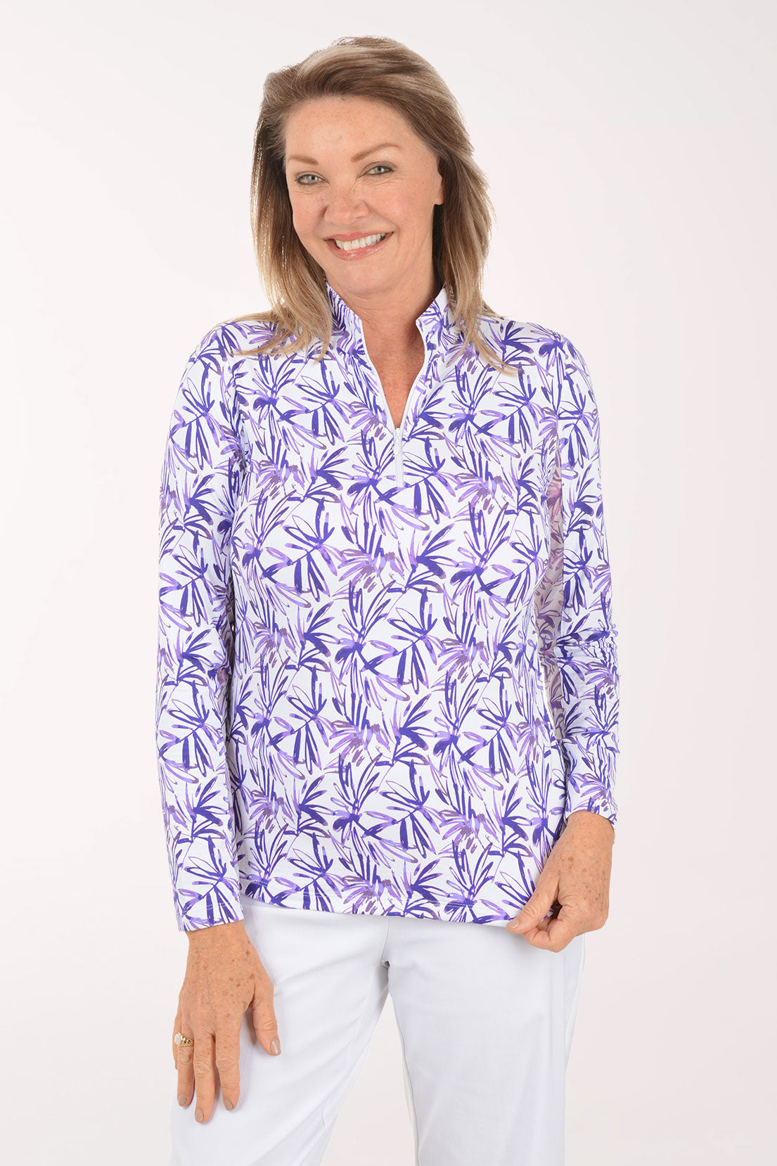 Woman wearing a purple floral patterned shirt on a white background