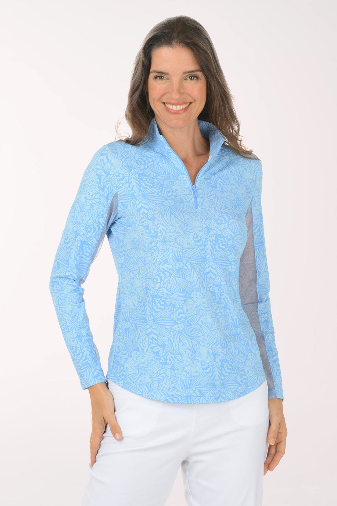 Woman wearing a light blue long-sleeve shirt with mesh accents on a white background