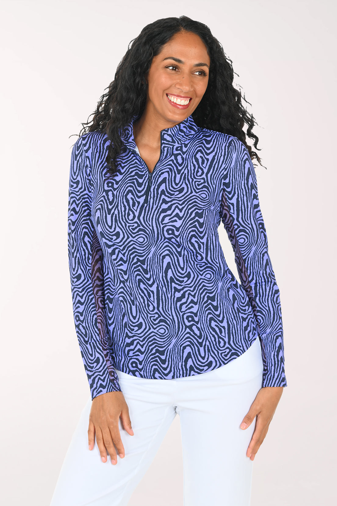 Woman wearing a blue patterned long-sleeve top on a white background