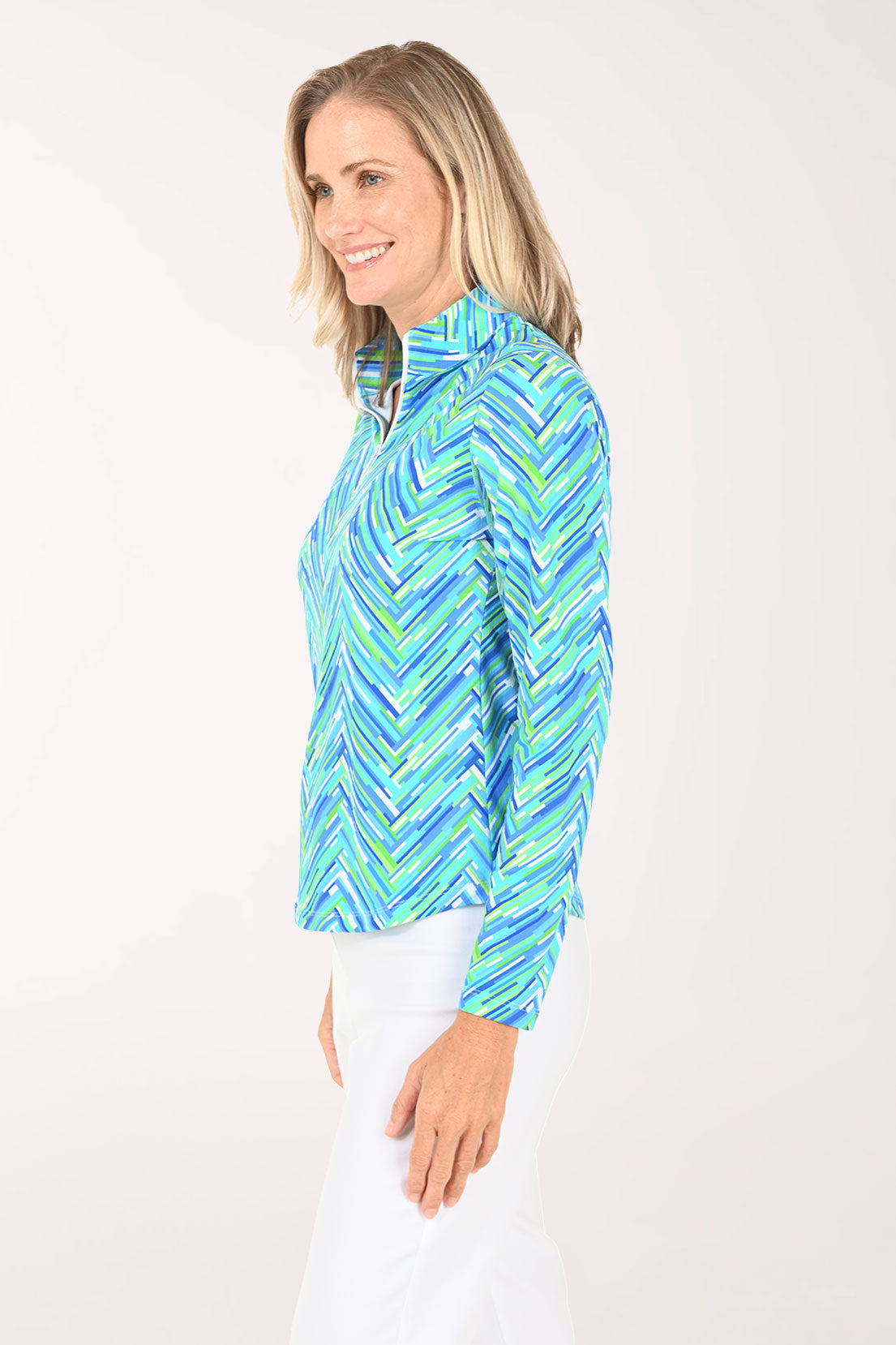 Woman wearing a blue and green patterned long-sleeve shirt on a white background