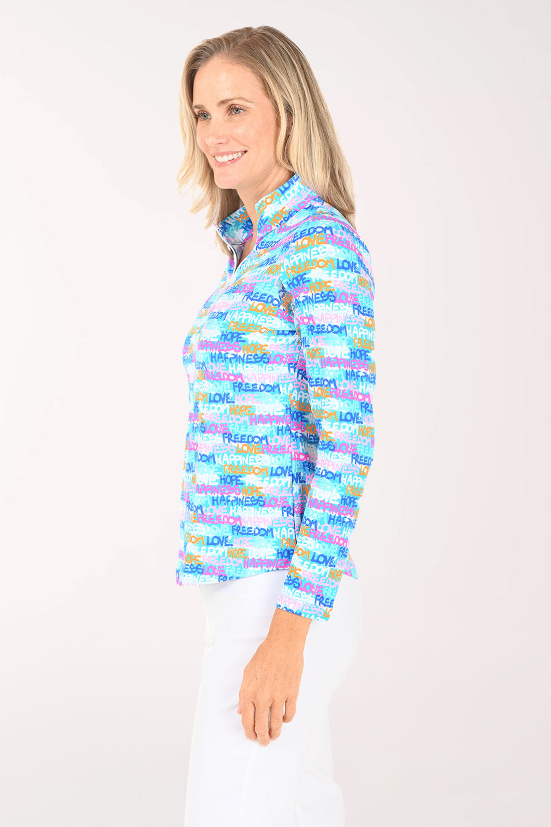 Woman wearing a colorful patterned shirt with text on a white background