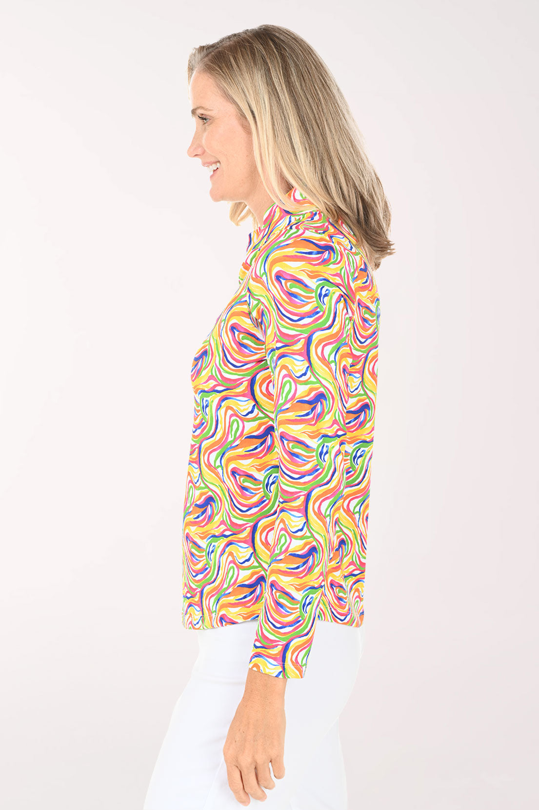 Woman wearing a colorful patterned shirt on a white background