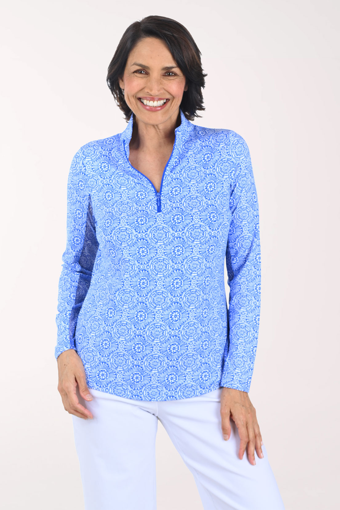 Woman wearing a blue patterned long-sleeve shirt on a white background