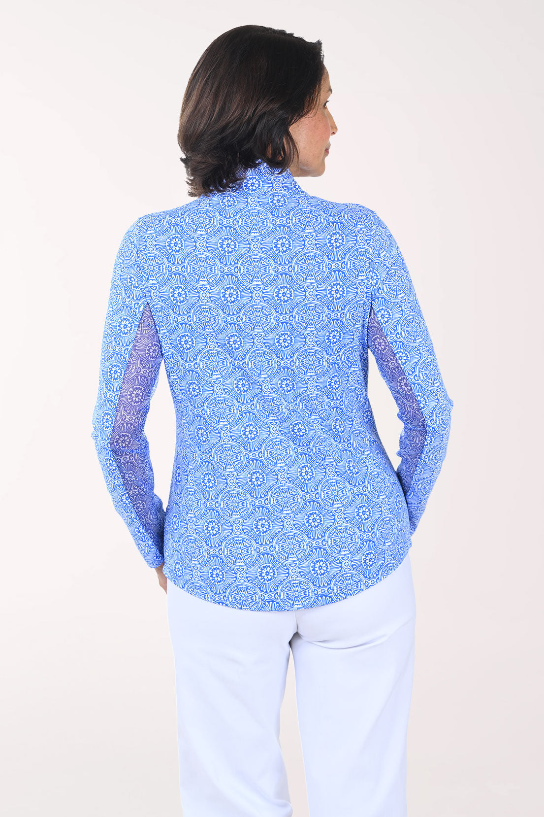 Woman wearing a blue patterned long-sleeve shirt on a white background