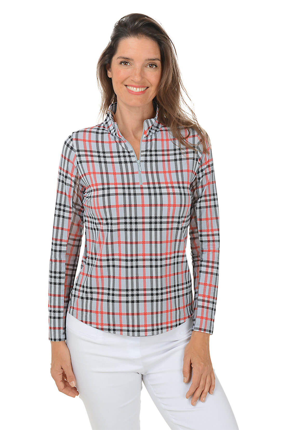 A woman wearing a red, black, and white plaid sun shirt with a mock neck and quarter-zip styling, paired with white pants.