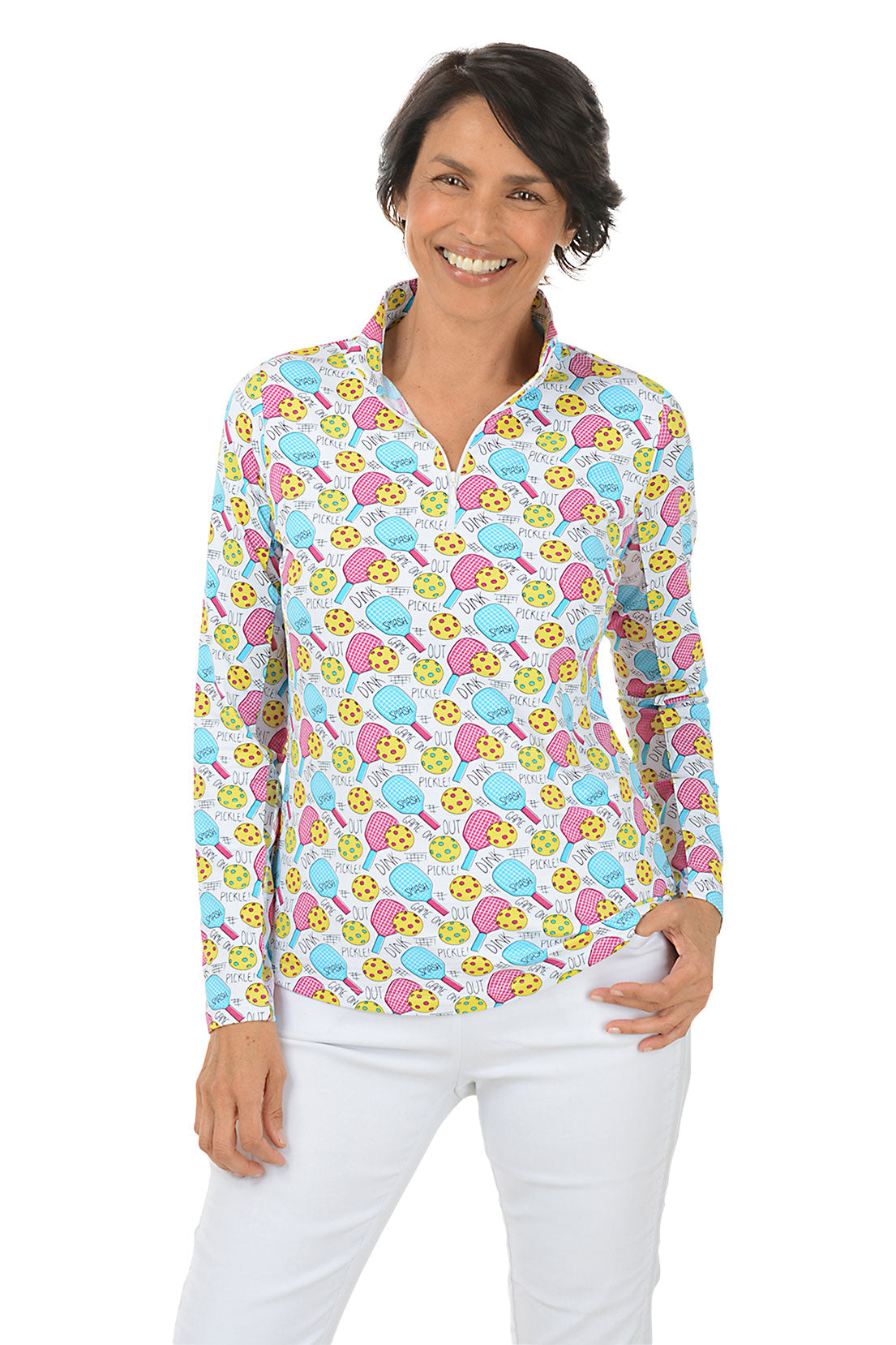 A woman wearing a long sleeve sun shirt with a vibrant pickleball pattern, featuring a mock neck and quarter-zip styling.