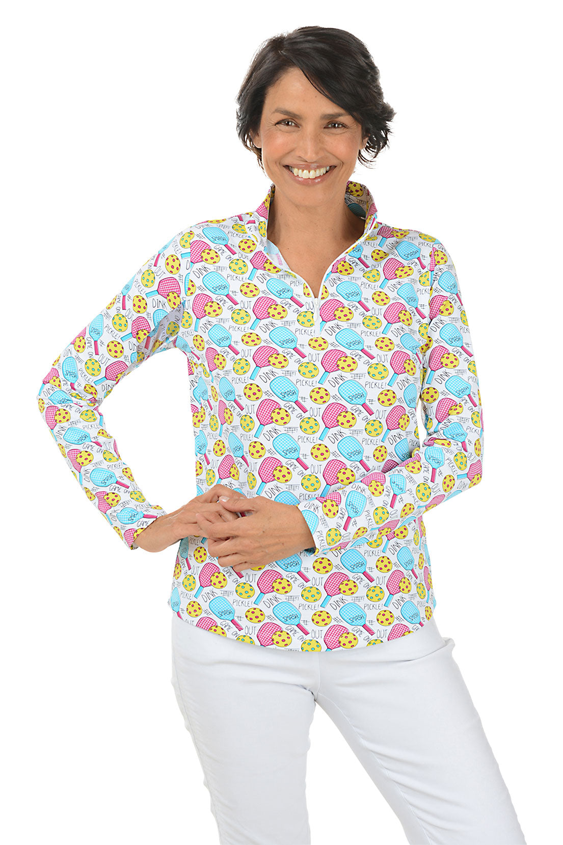 A woman wearing a long sleeve sun shirt with a vibrant pickleball pattern, featuring a mock neck and quarter-zip styling. Second front shot.