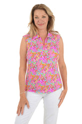 Woman wearing a colorful floral sleeveless blouse on a white background.