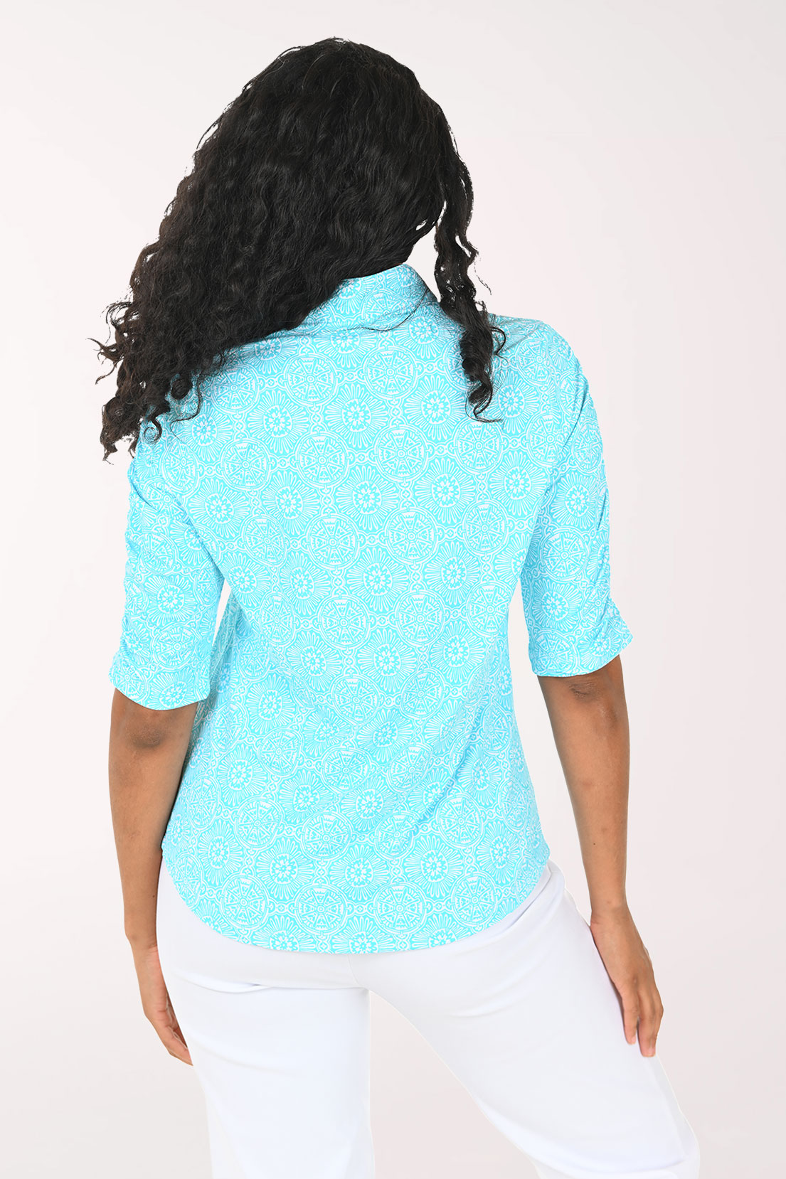 Woman wearing a light blue short-sleeve shirt with a white background