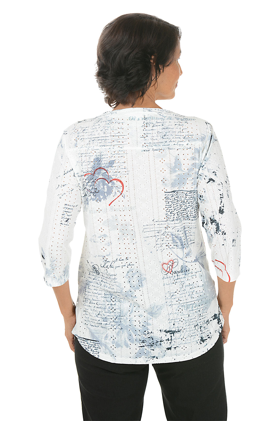 Woman wearing a white blouse with abstract designs on a white background. Back shot.