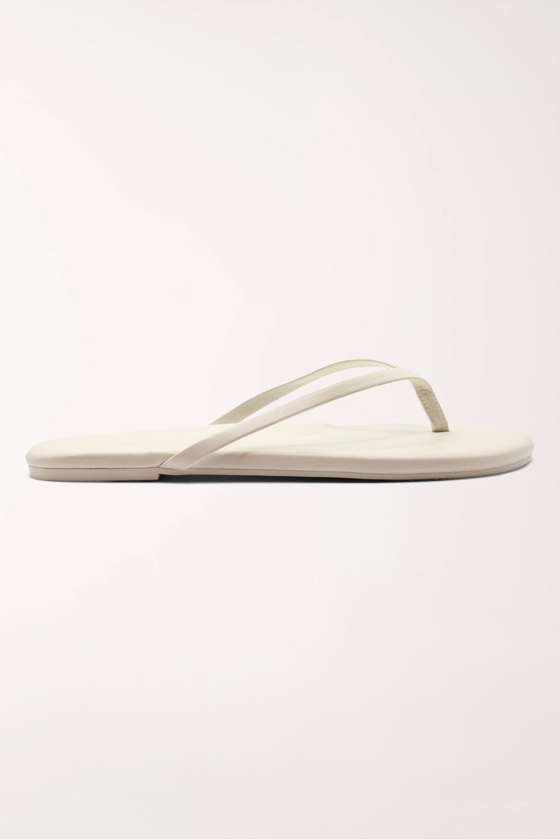 Pair of white flip-flops on a light gray background