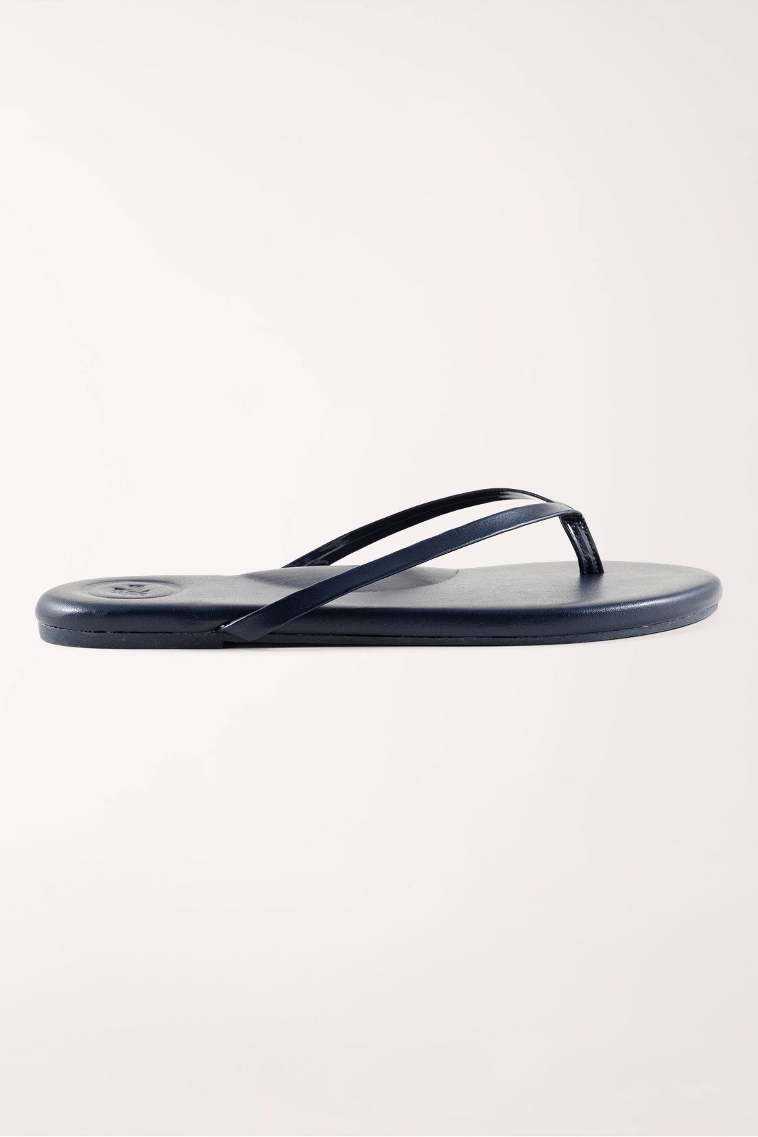 Pair of navy blue flip-flops on a white background
