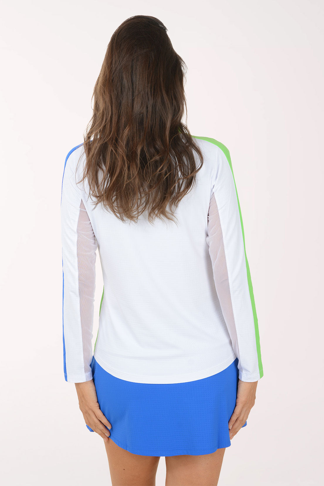 Woman wearing a white long-sleeve shirt with green and blue accents on a white background