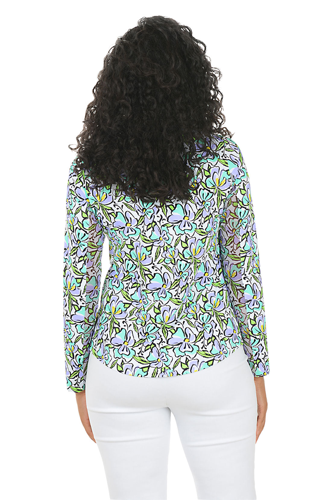 Woman wearing a colorful floral blouse with white pants on a white background. Back shot.