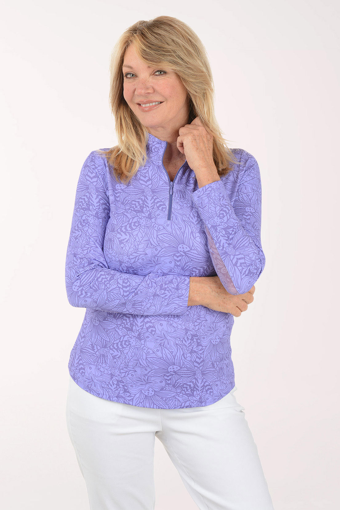 Woman wearing a purple long-sleeve top with a white background