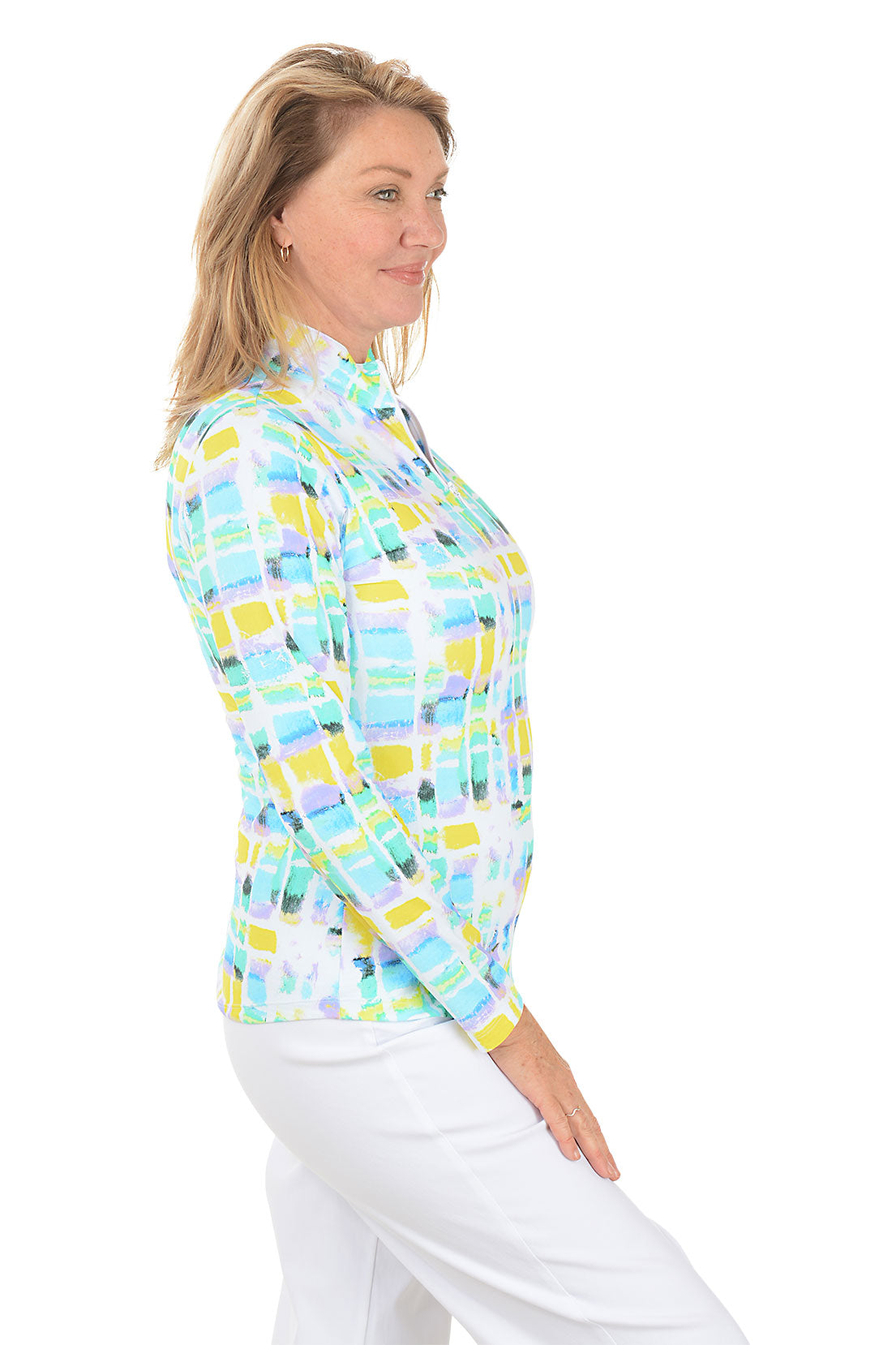 Woman wearing a colorful checkered shirt with a white background. Side shot.