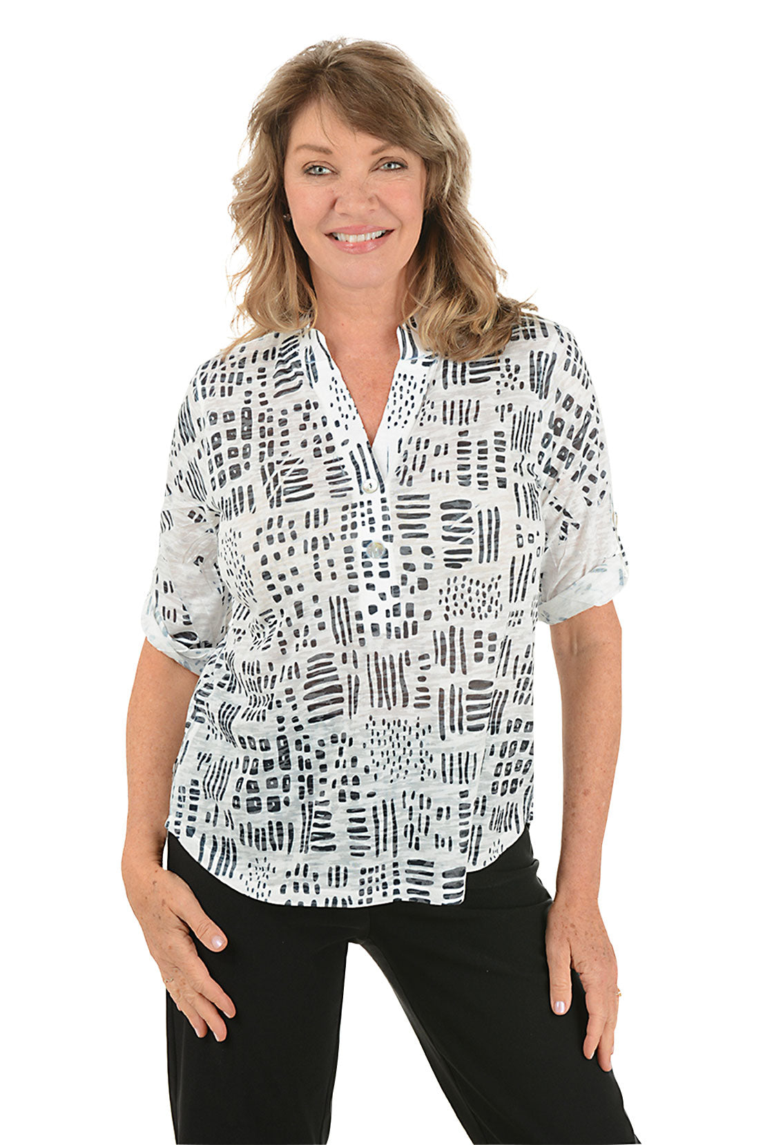 A woman wearing a 3/4 roll sleeve black and white top.