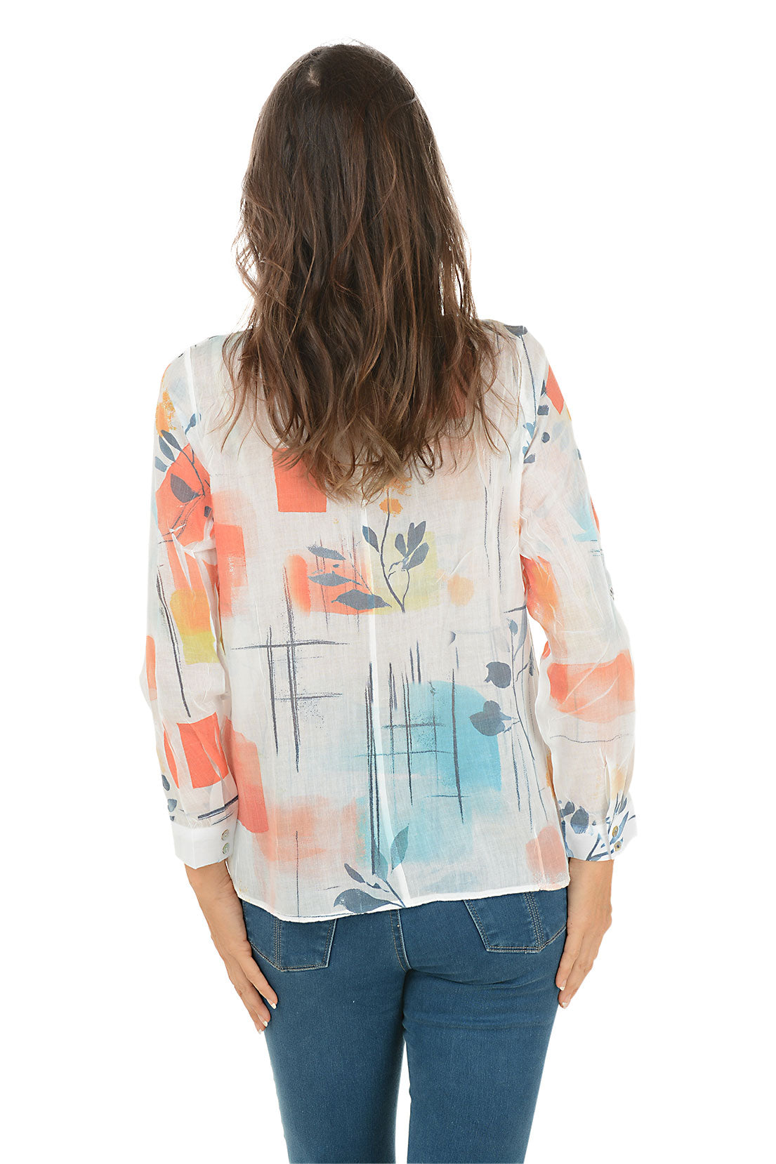 Woman wearing a colorful floral blouse with blue jeans on a white background. Back shot.