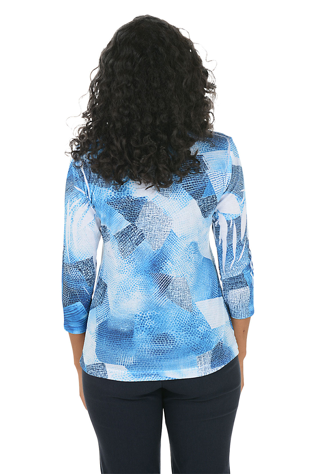 Woman wearing a blue abstract patterned top on a white background. Back shot.