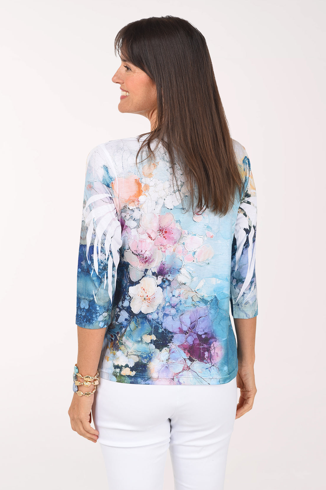 Back view of the Celestial Garden top showing watercolor florals across the back and 3/4 sleeves.