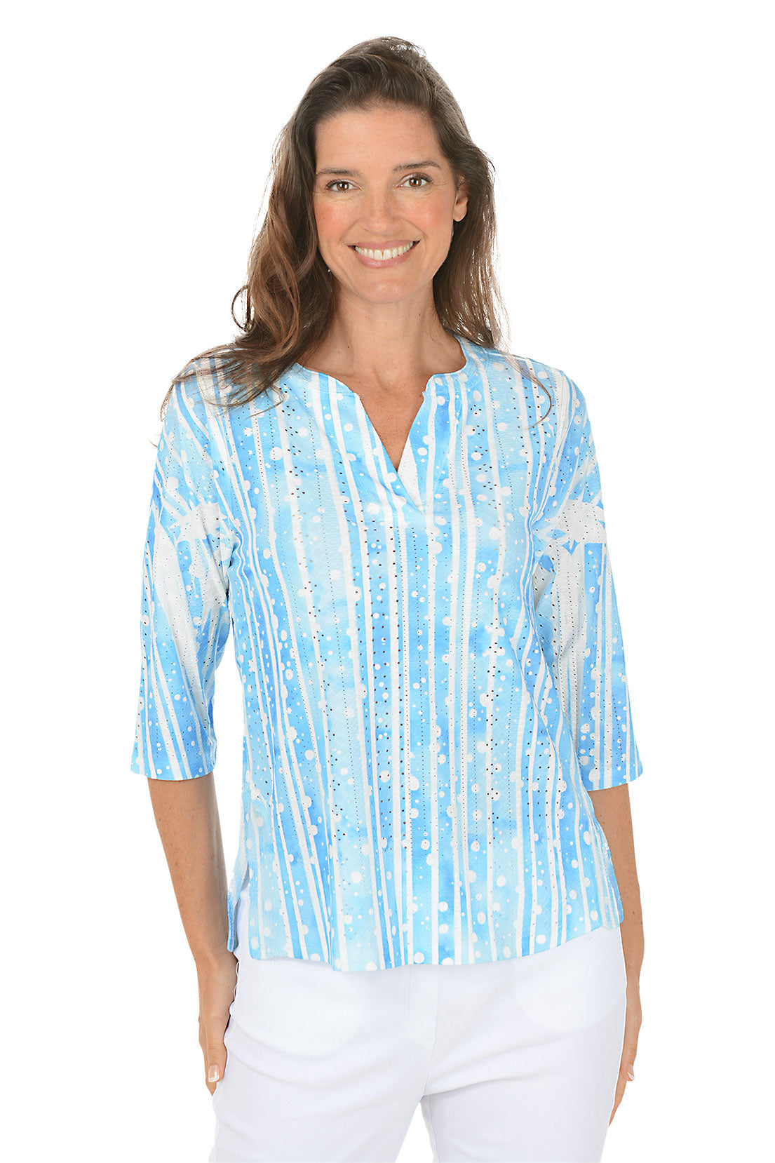 Woman wearing a blue and white patterned blouse on a white background.