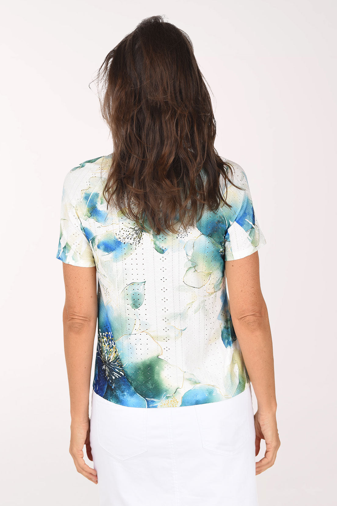 Back view of the top with blue and green watercolor blooms and eyelet texture across the back
