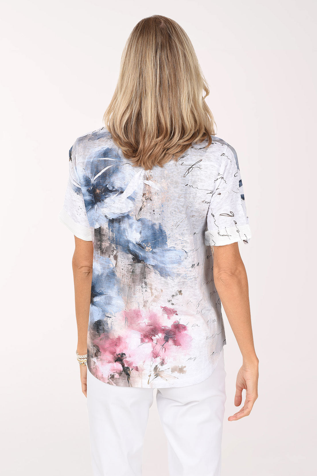 Back view of the Poet Garden Sequin Accented Polo Top with blue florals and a center back pleat