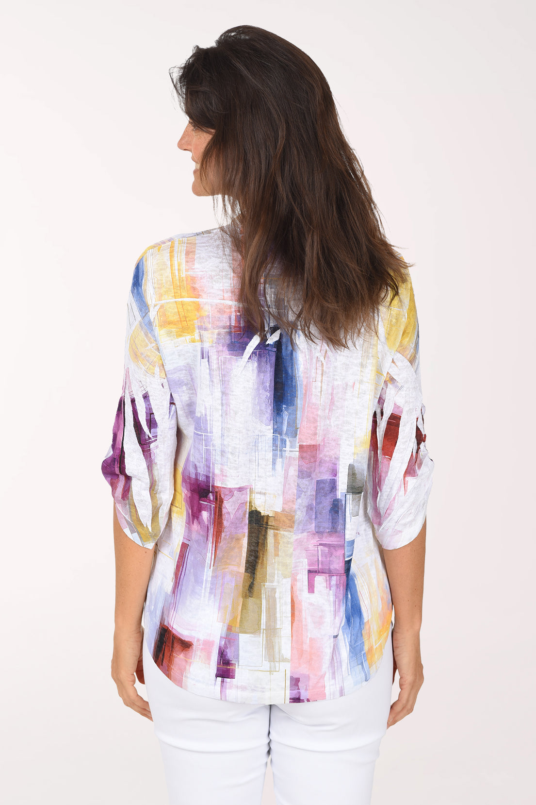 Back view of the top with violet, pink and yellow brushstrokes across the back and rolled sleeves