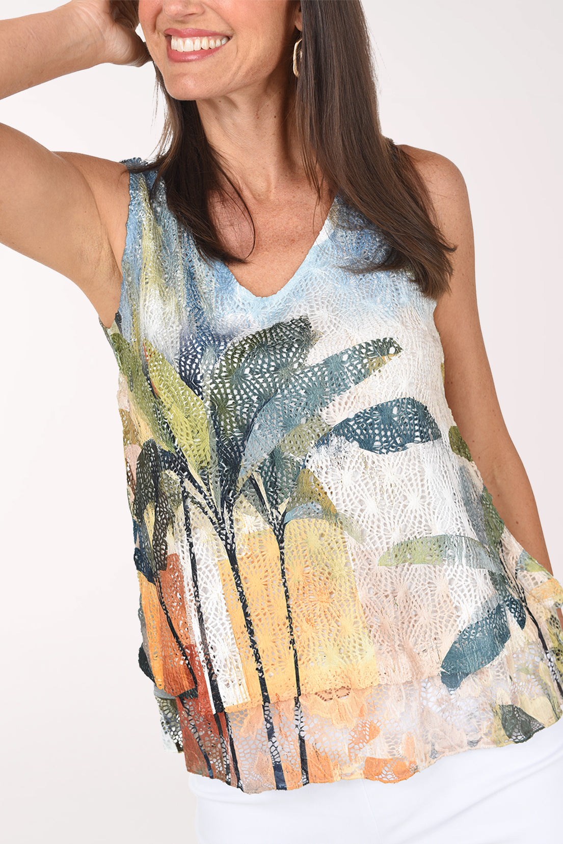 Front close-up of the Palm Beach crochet top showing the open crochet texture, palm fronds and sunset colors.