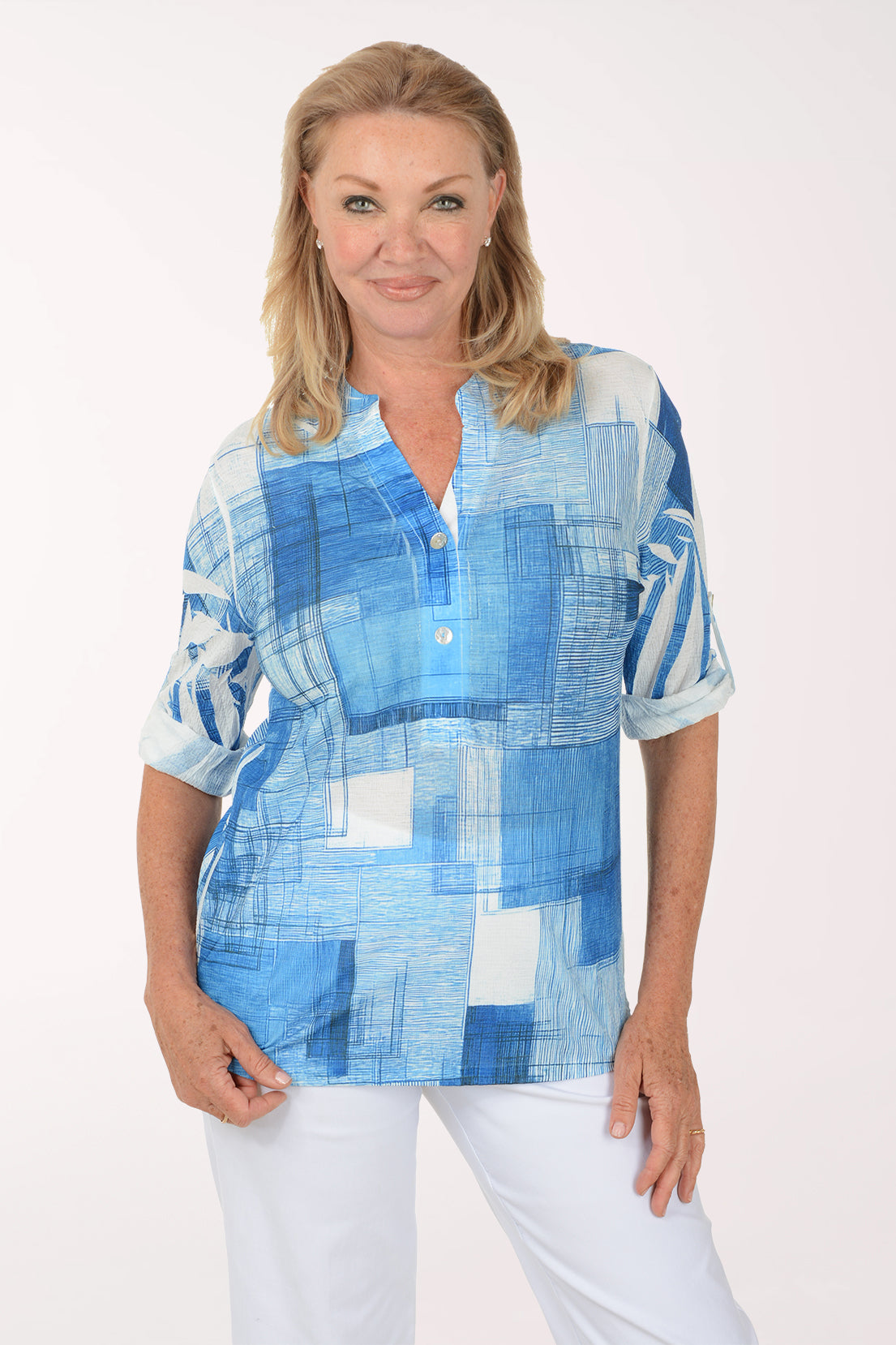 Woman wearing a blue plaid shirt with a white background