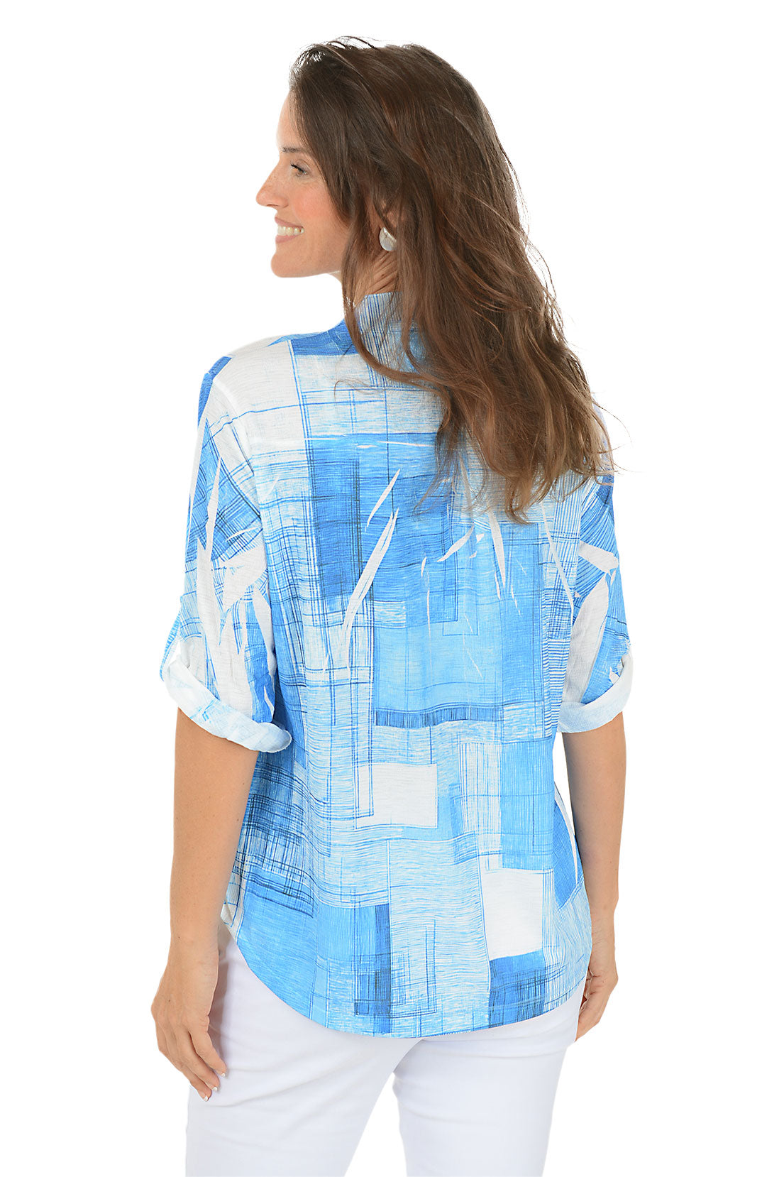 Woman wearing a blue abstract patterned shirt on a white background. Back shot.