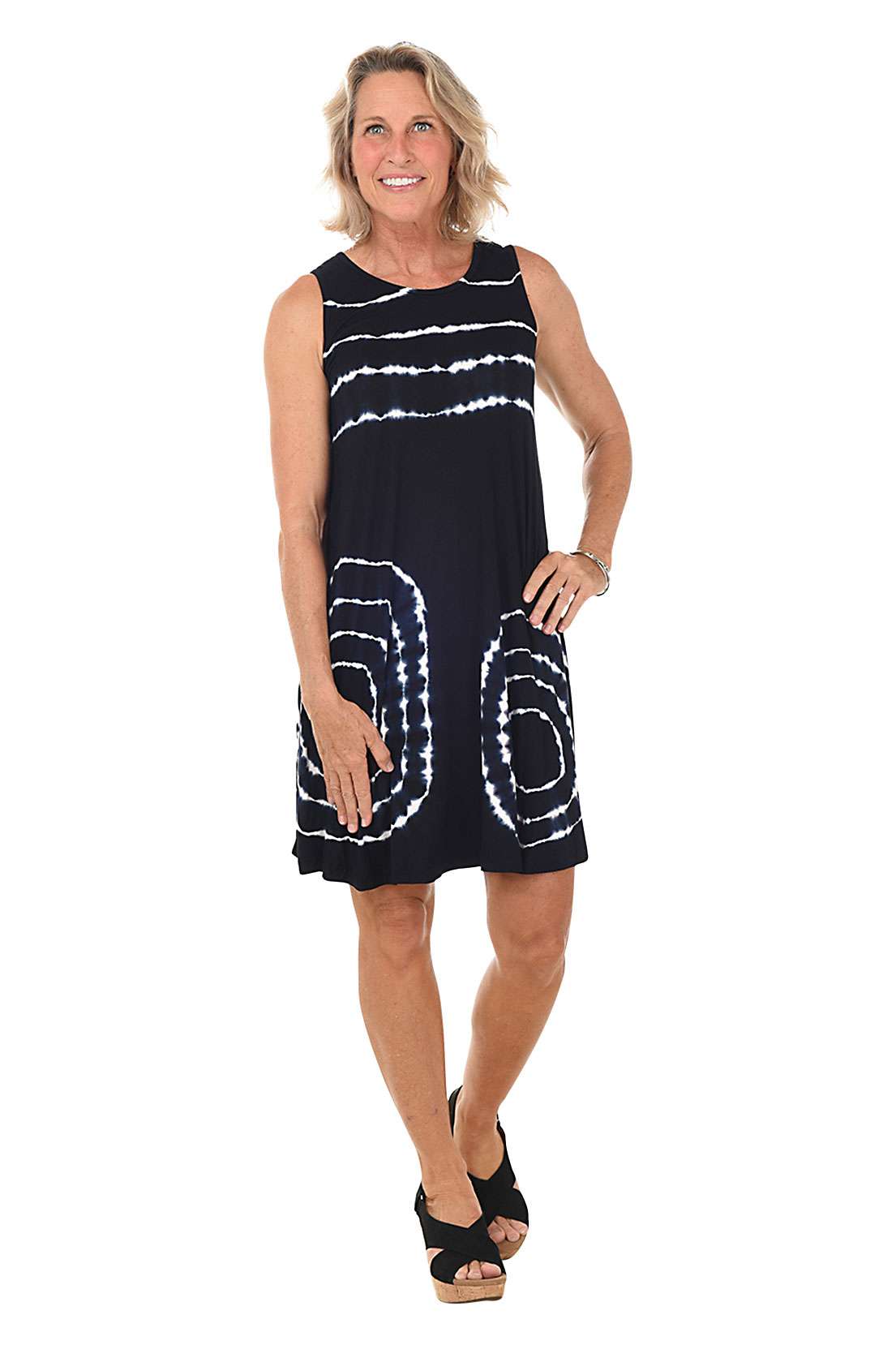 Woman wearing a black and white patterned dress on a white background.