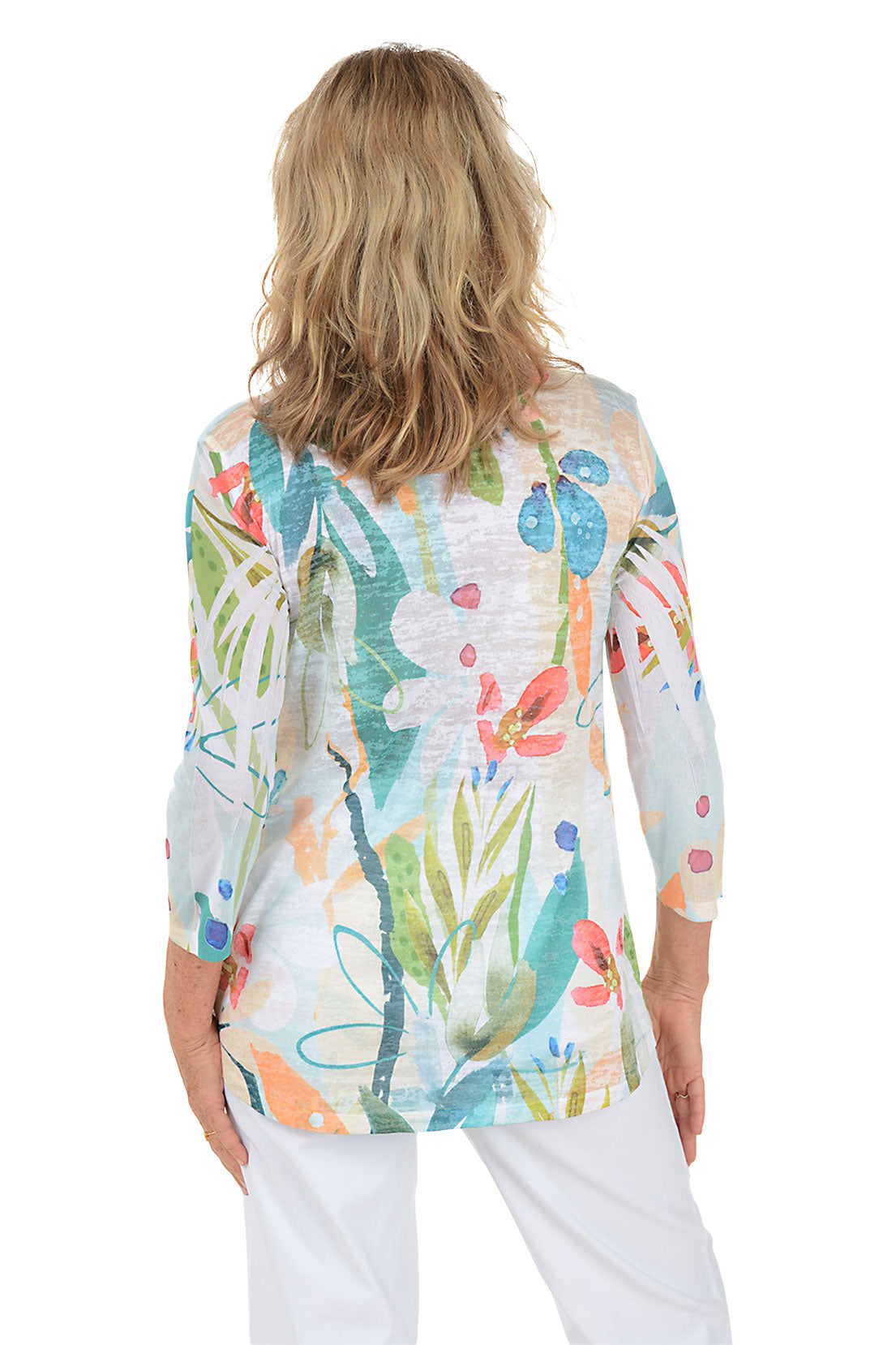 A woman wearing a white 3/4 sleeve abstract floral shirt. Back shot.
