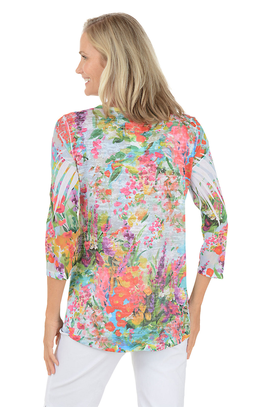 A woman wearing a floral patterned 3/4 sleeve top. Back shot.
