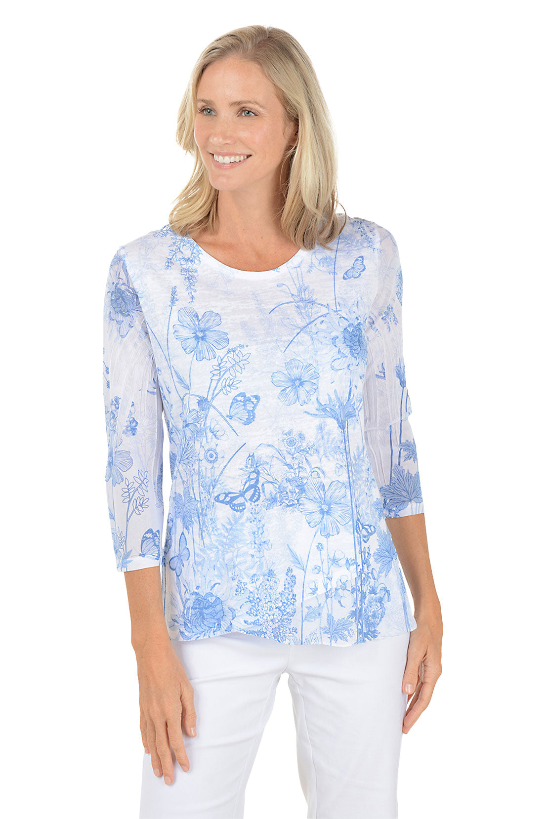 A woman wearing 3/4 sleeve white and blue top with a floral pattern.