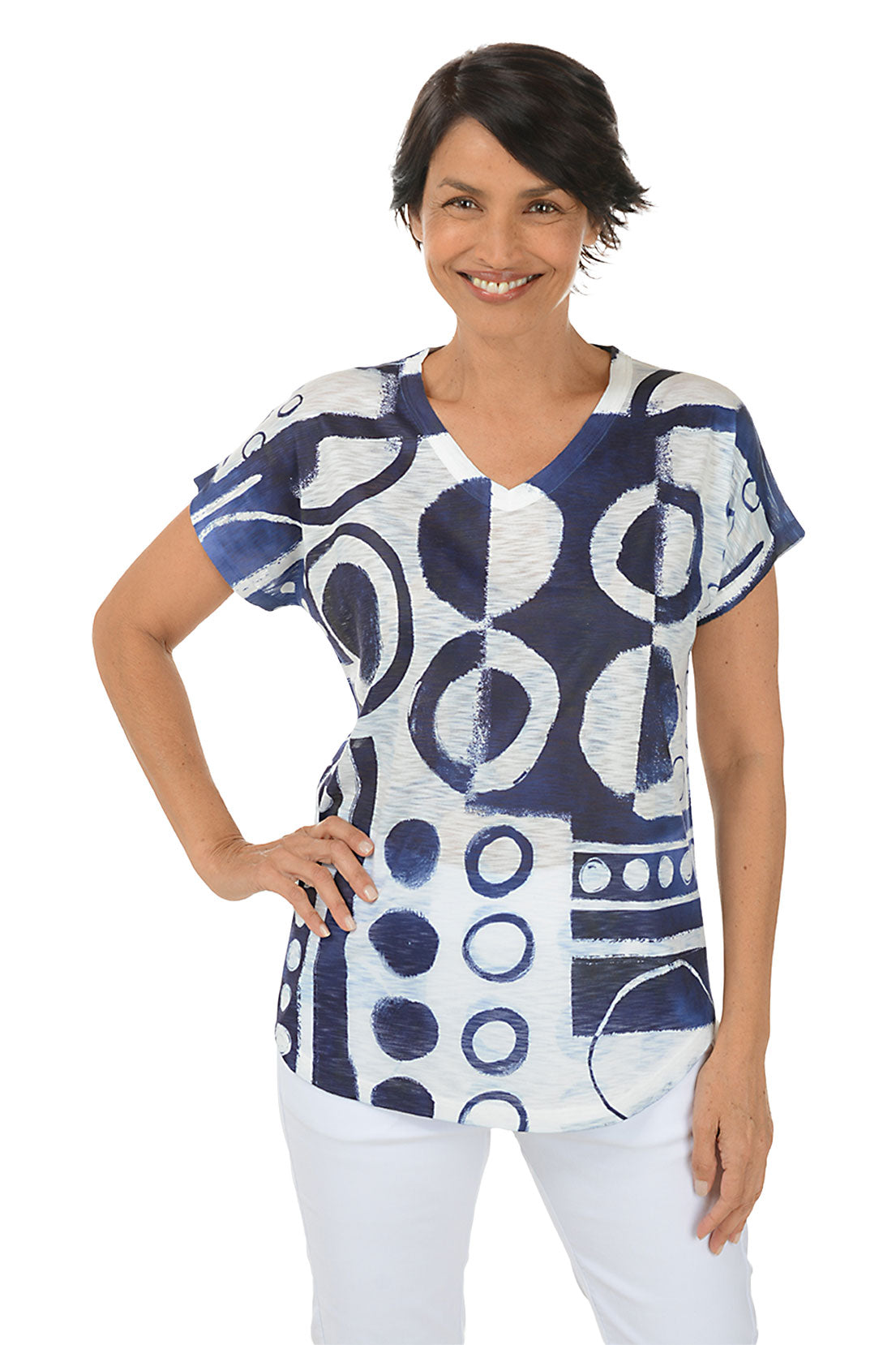 A front shot of a model wearing a navy blue and white geometric patterned petite top with short sleeves and a V-neck.