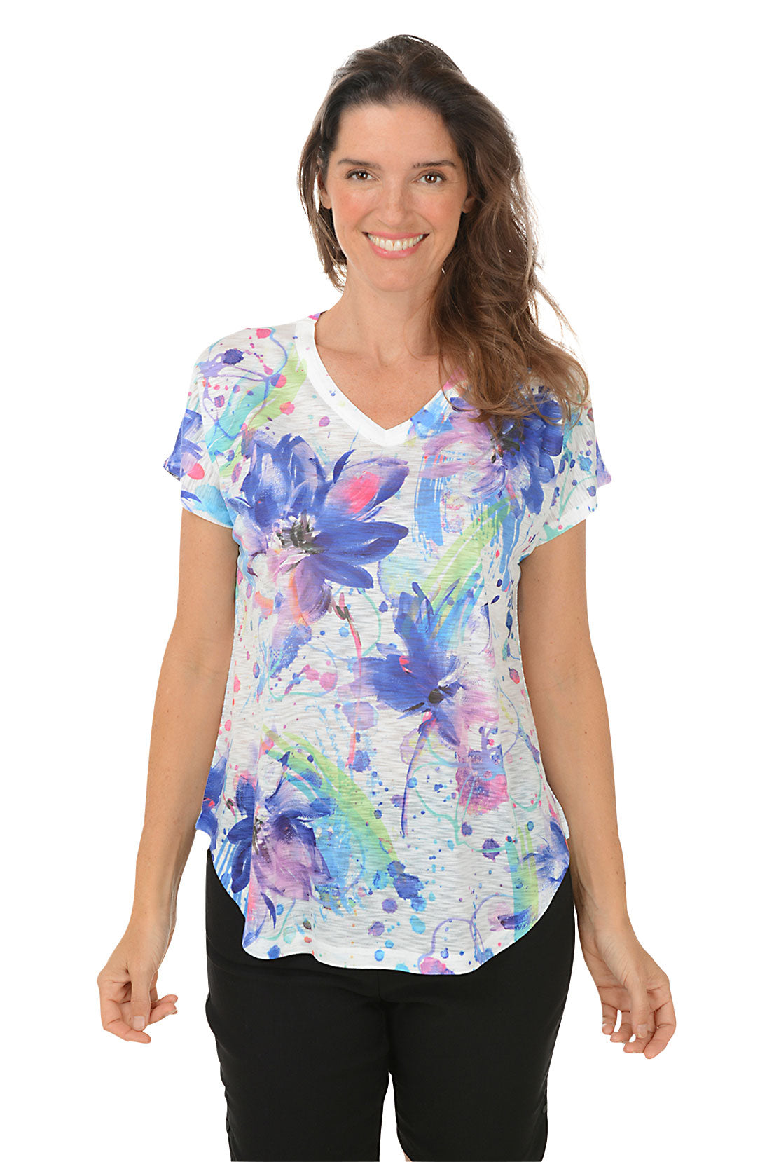 A woman wearing a multi colored floral short sleeve top.