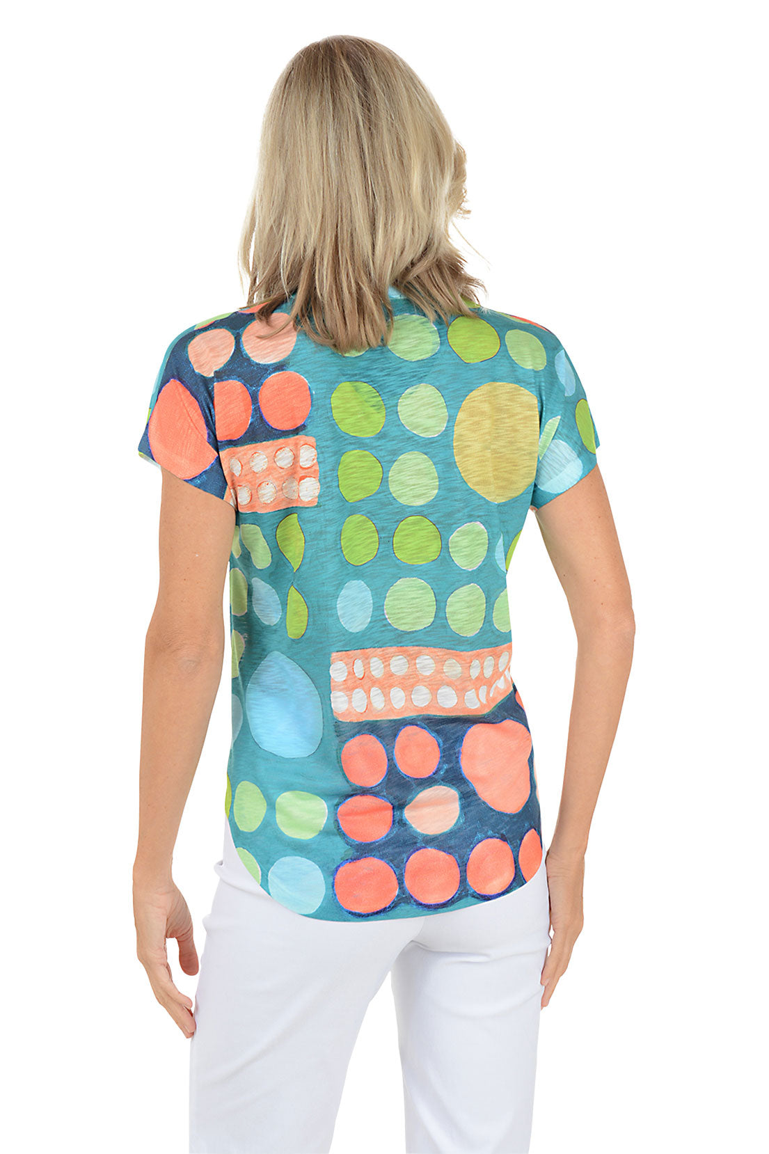 A woman wearing a short sleeve multicolored abstract top. Back shot.