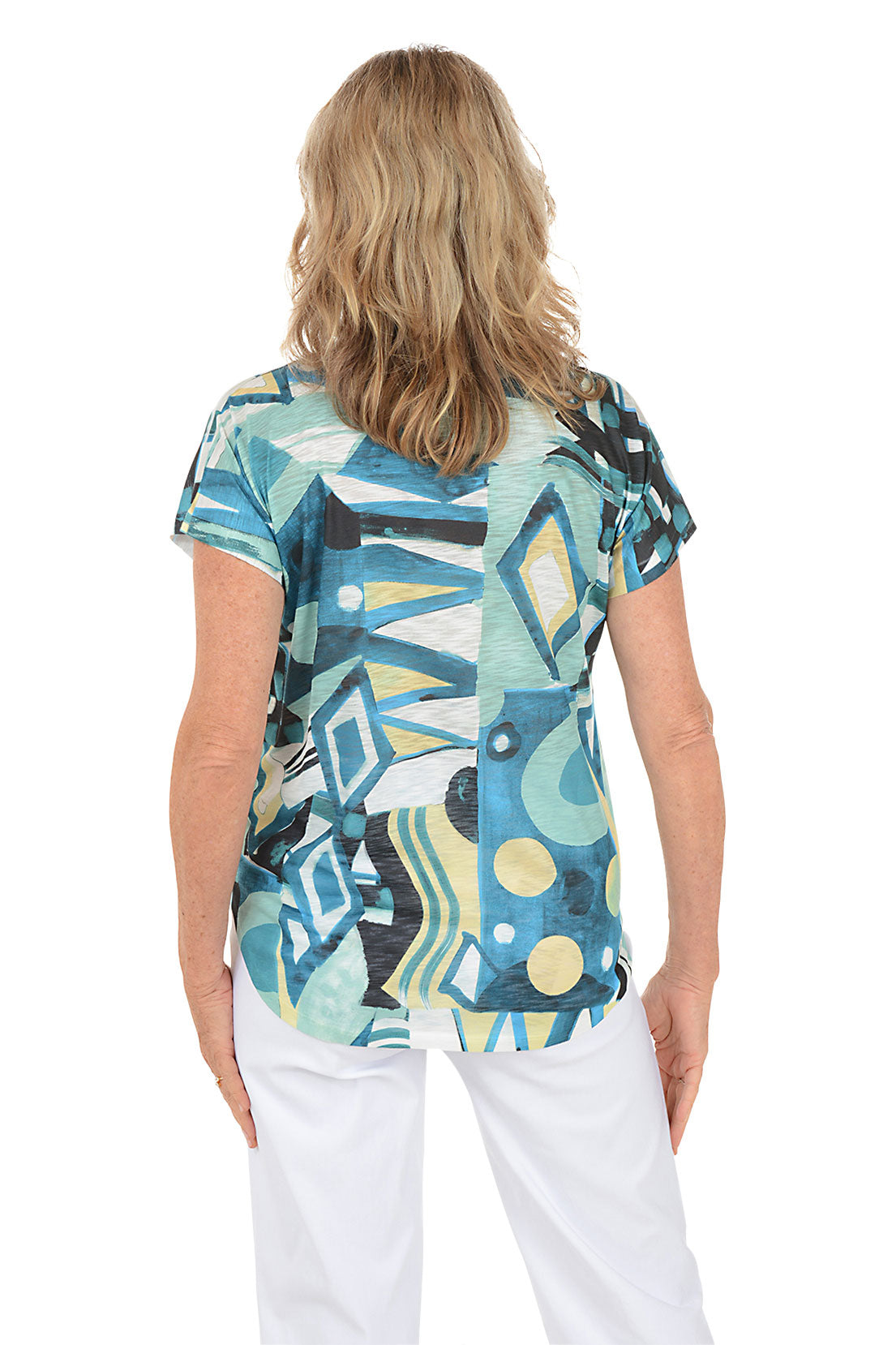Woman wearing a colorful abstract patterned top on a white background. Back shot.