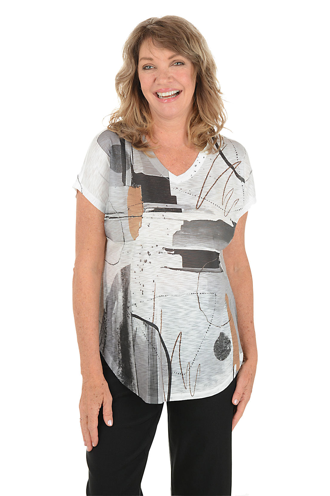 A woman wearing a black and white short sleeve v-neck shirt with an abstract design.