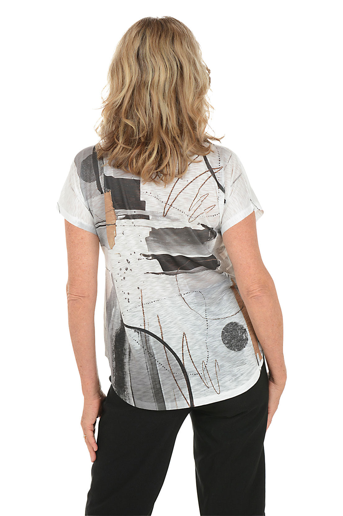 A woman wearing a black and white short sleeve v-neck shirt with an abstract design. Back shot.